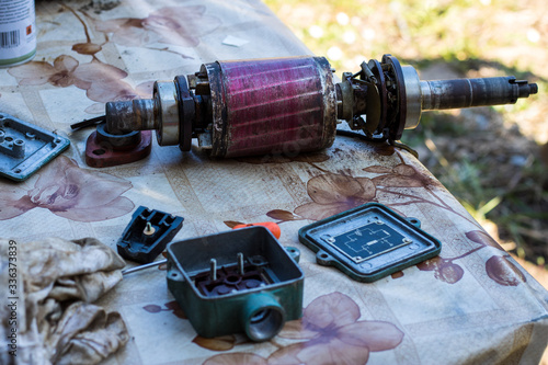 Disassembled single-phase water pump for agricultural irrigation. Broken water pump in the yard
