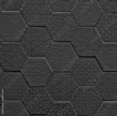 Black ceramic tile with geometric rhombus pattern for wall and floor decoration. Concrete stone surface background. Solid texture for interior design project.