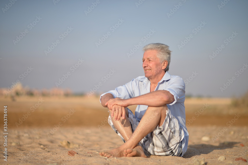 Portrait of happy senior man at tropical resort