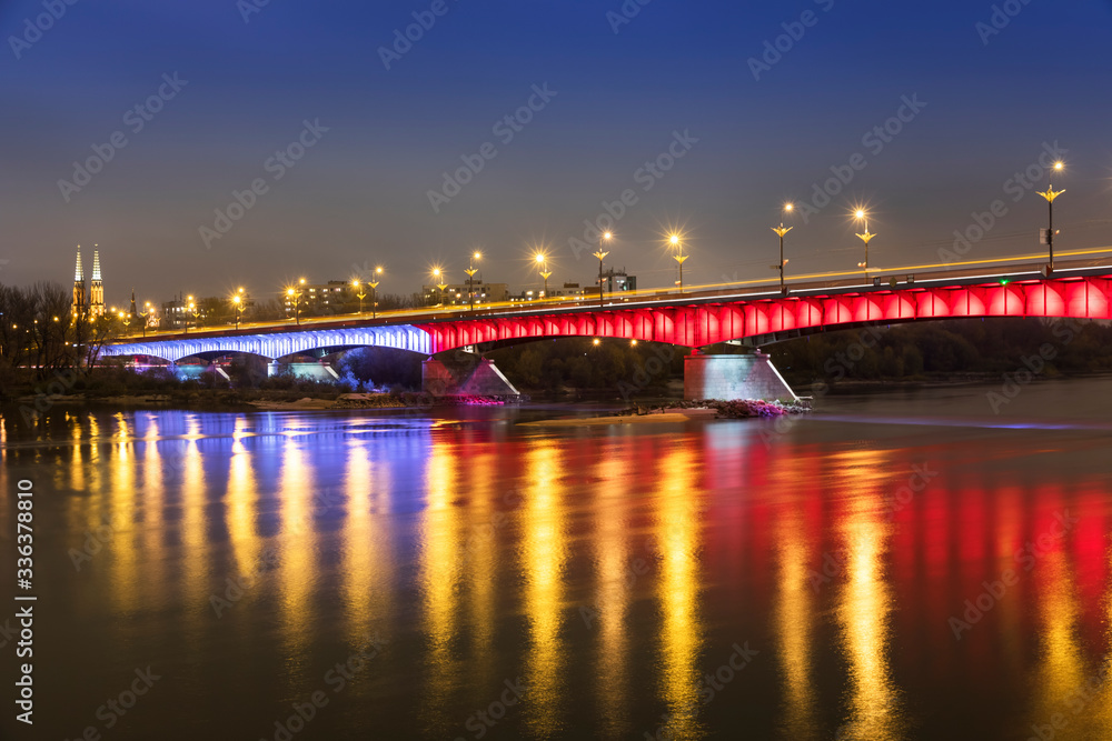 Modern illuminated bridge in Warsaw - capital of Poland. Boulevards on the Vistula river.