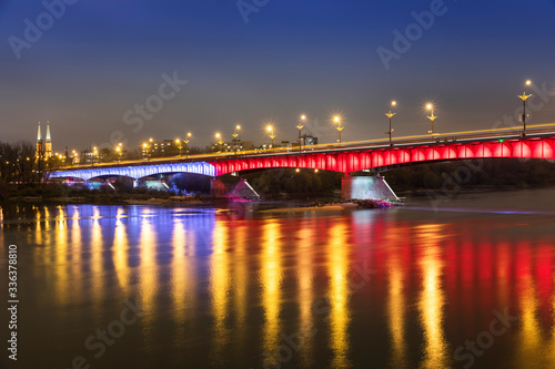 Modern illuminated bridge in Warsaw - capital of Poland. Boulevards on the Vistula river.