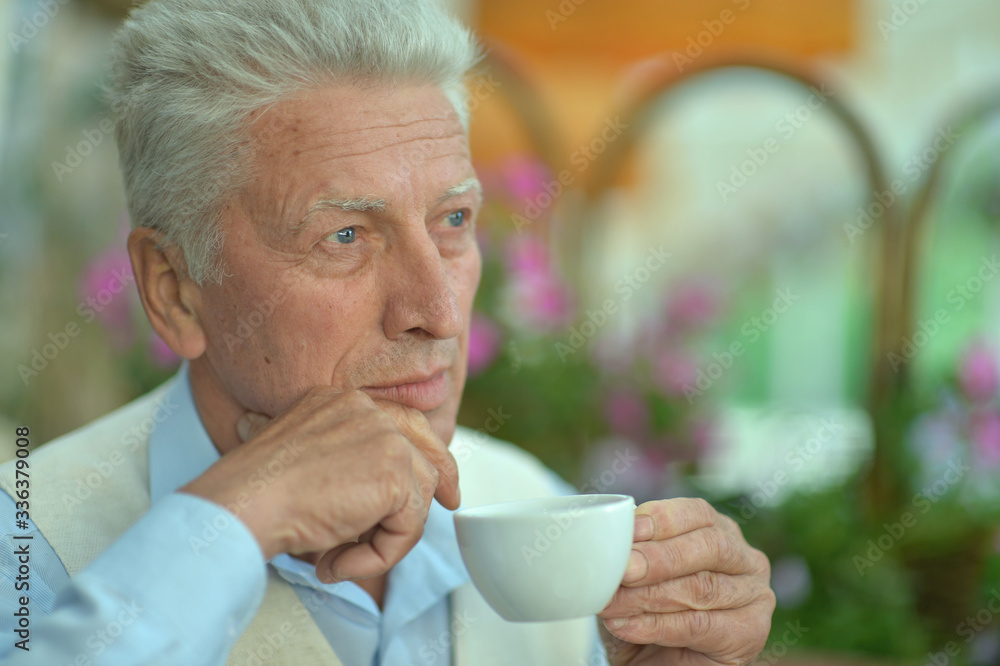 Portrait of smiling senior man drinking coffee Portrait of smiling senior man drinking coffee