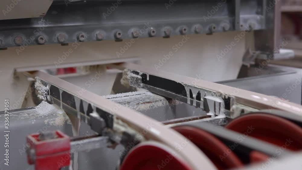 Production of ceramics, ceramic tiles are moving on the paint line conveyor. Production of ceramics, ceramic tiles are moving on the paint line conveyor.