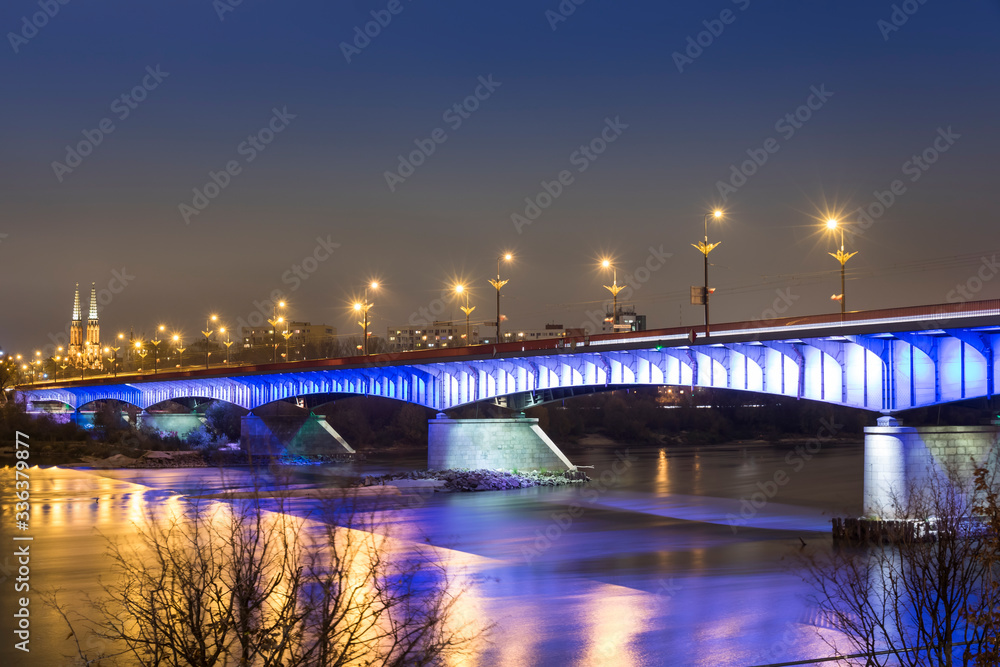 Modern illuminated bridge in Warsaw - capital of Poland. Boulevards on the Vistula river.