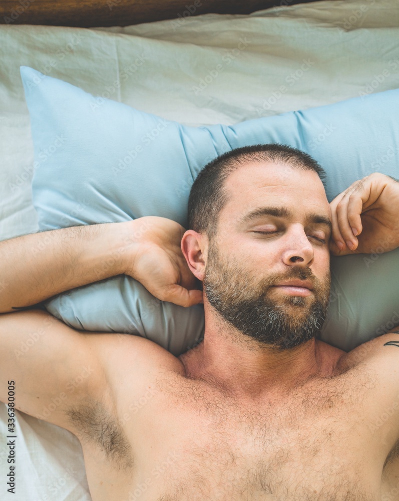 Obraz premium Man sleeping in bed at home