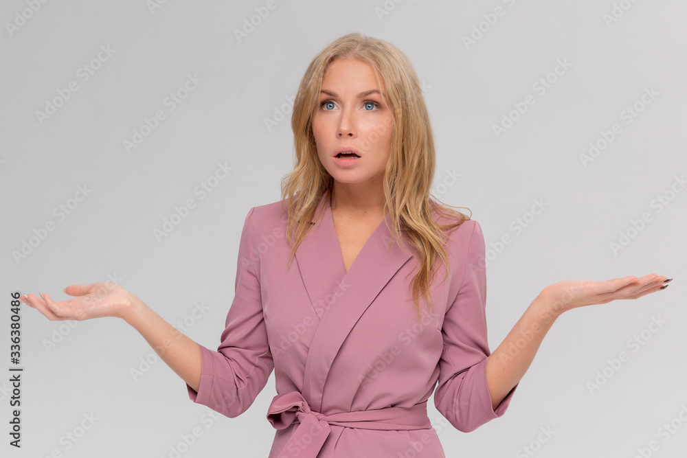 Studio portrait of cute puzzled hesitant young woman shrugs shoulders, does not know what happened. Pretty attractive woman doubting isolated on gray background Studio portrait of cute puzzled hesitant young woman shrugs shoulders, does not know what happened. Pretty attractive woman doubting isolated on gray background