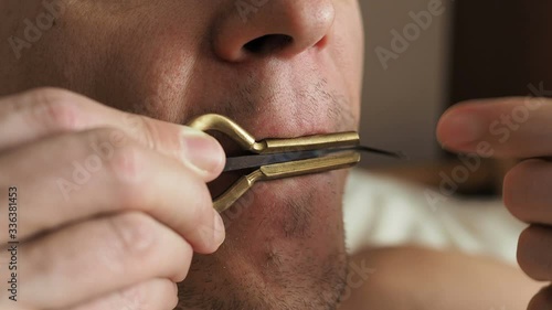 man plays music on vargan