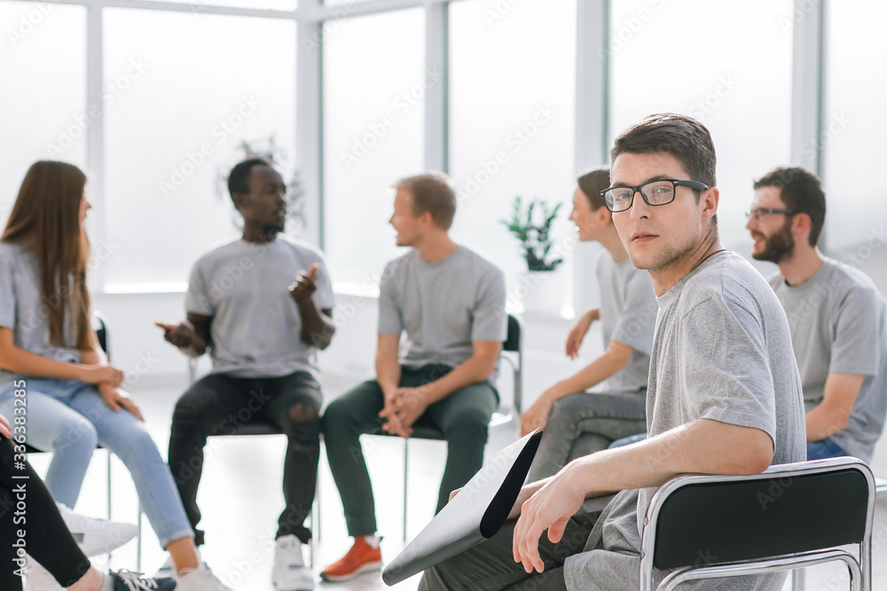 handsome guy sitting in a circle with like-minded person handsome guy sitting in a circle with like-minded person