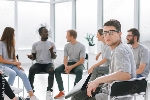 handsome guy sitting in a circle with like-minded person