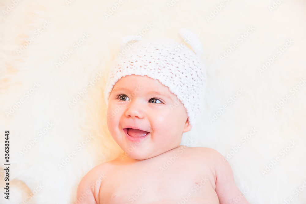 Cute Baby Girl Laughing and Wearing a Soft Knit Bear Ears Hat Cute Baby Girl Laughing and Wearing a Soft Knit Bear Ears Hat