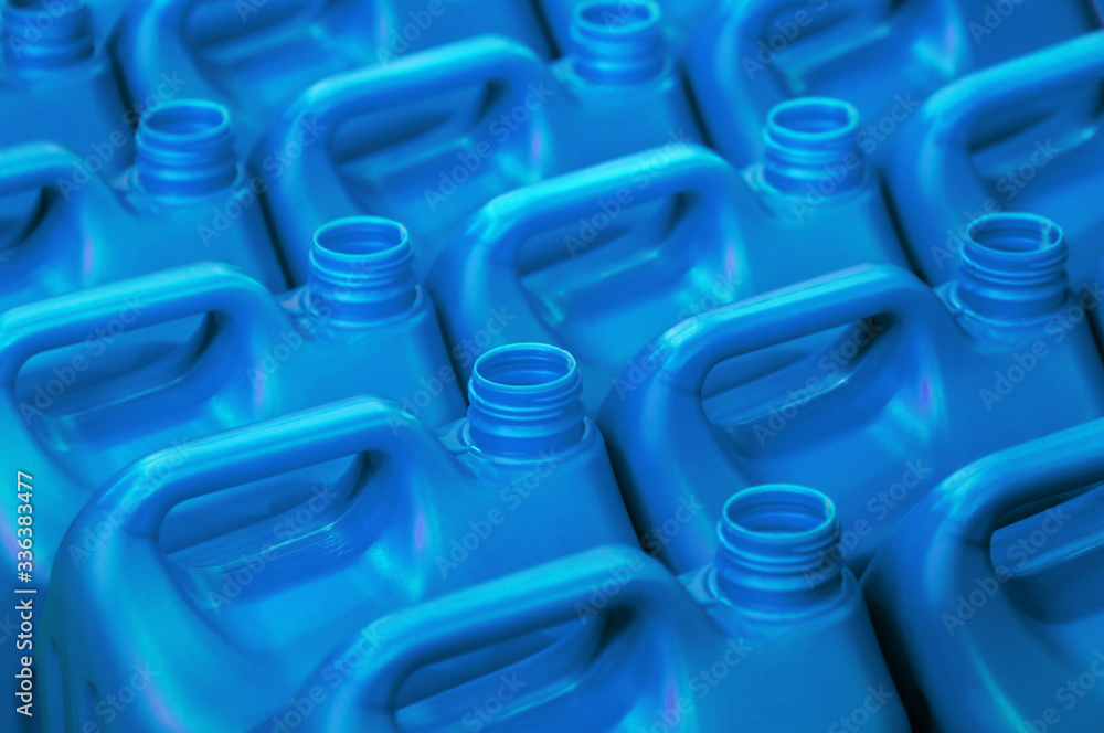 Fototapeta premium plastic canisters of light blue color in the warehouse, production, factory. Background from plastic canisters