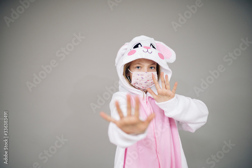 beautiful girl dressed as easter bunny rabbit with face protective mask during the corona  corvid 19 lockdown