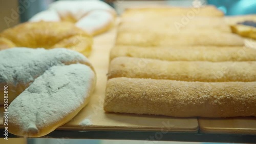 left right camera pan fresh and tasty bakery products through bakery window in the coffee shop, slow motion photo