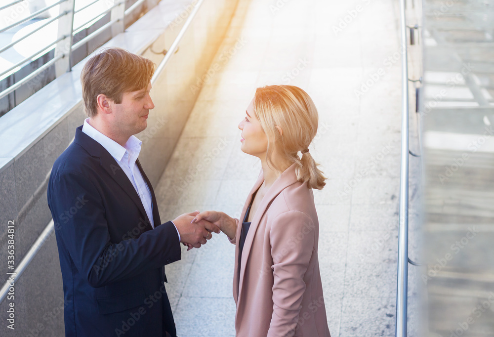 Fototapeta premium Business men and business women shake hands in greeting