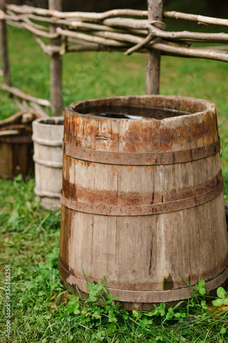 water barrels in the garden on the grass. © annarozova