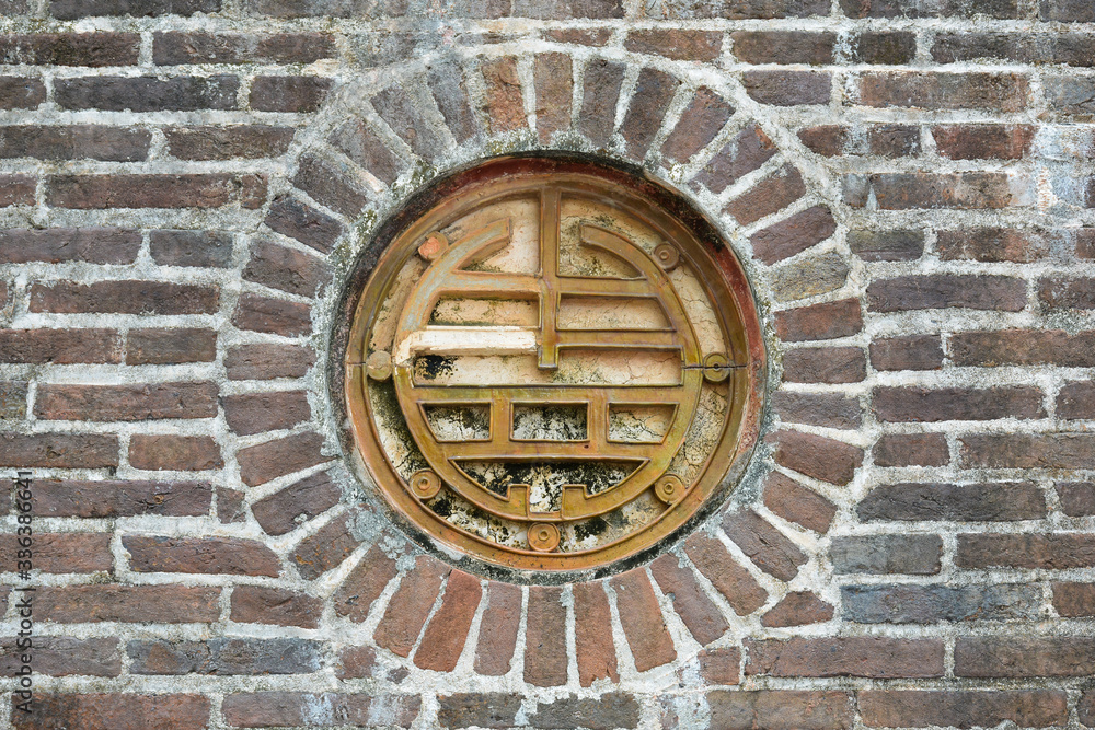 Decorated porthole in the Tomb of Tu Duc. Hue, Vietnam