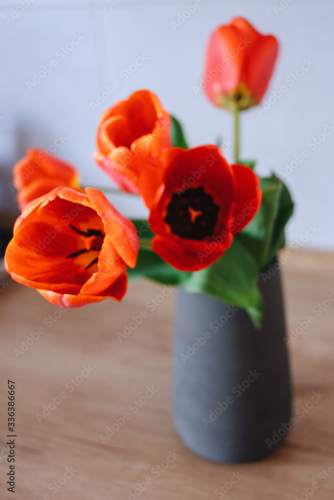 Bouquet of tulips in vase on wooden table Bouquet of tulips in vase on wooden table