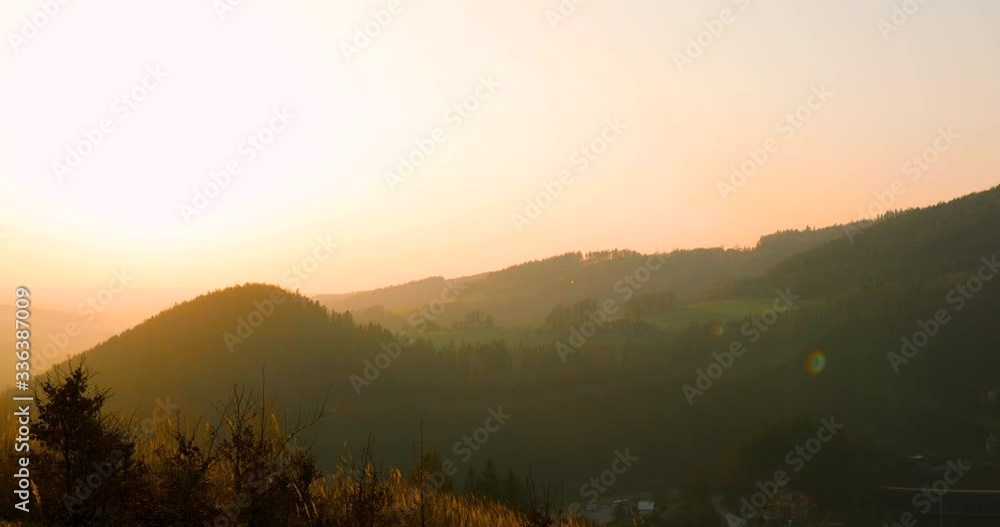 Panoramic view of nature around Bystricka dam during sunset climbs to see many mountains and hills full of fresh greenery grass moving in wind growing under hills during sunset captured in 4k 60fps Panoramic view of nature around Bystricka dam during sunset climbs to see many mountains and hills full of fresh greenery grass moving in wind growing under hills during sunset captured in 4k 60fps