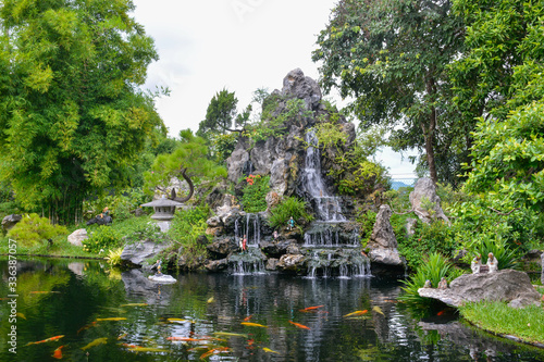 Garden with waterfalls and a pond in the Pagoda of the Celestial Lady. Hue, Vietnam