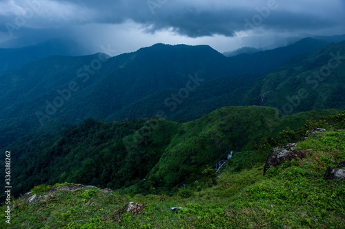 Beautiful landscape with green mountains and magnificent cloudy sky Parunthumpara.Exploring Kerala,India