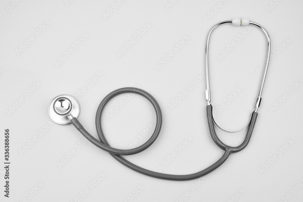 A stethoscope isolated on a white paper background in a wave formation A stethoscope isolated on a white paper background in a wave formation