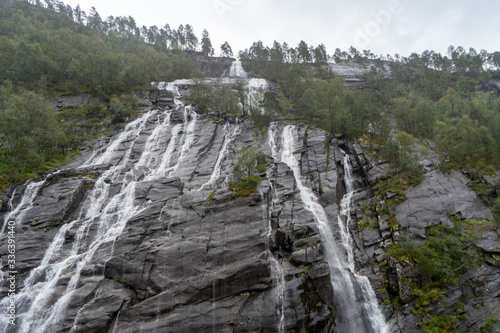 Amazing waterfall and mountain in Norway during the Mostraumen fjord cruise from Bergen in August 2019