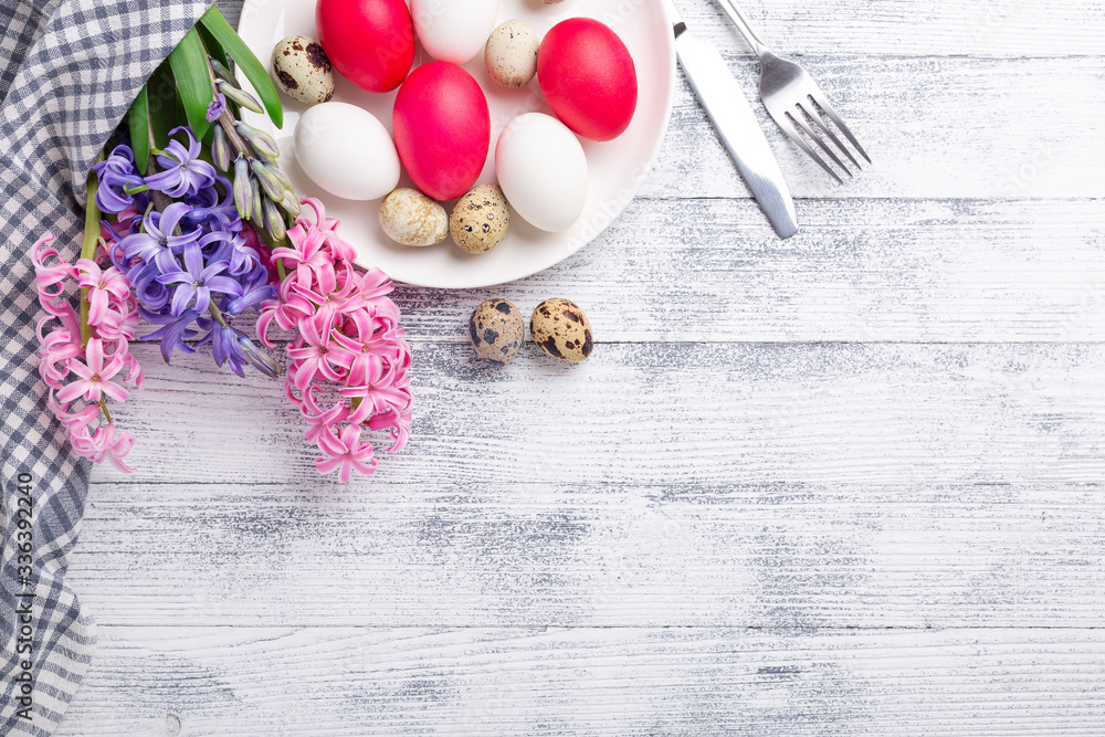 Easter eggs, pink and white hyacinth on wooden background. Easter concept. Top view. Copy space