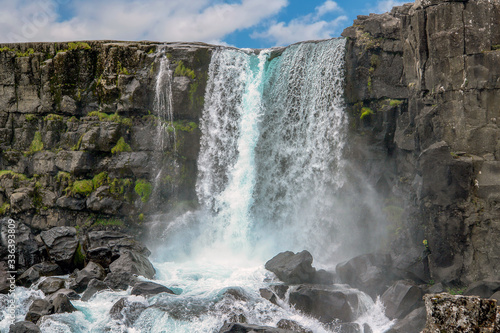 Oxararfoss waterfall in Thingvellir National park  Iceland. It flows from the river Oxara over the Almannagja.