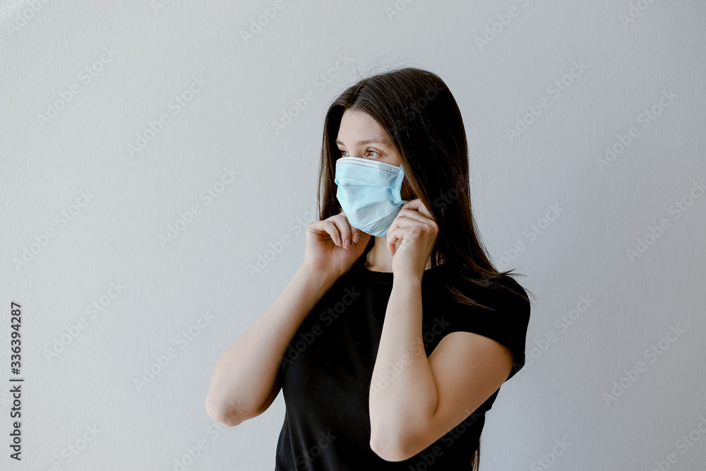 woman puts on face mask