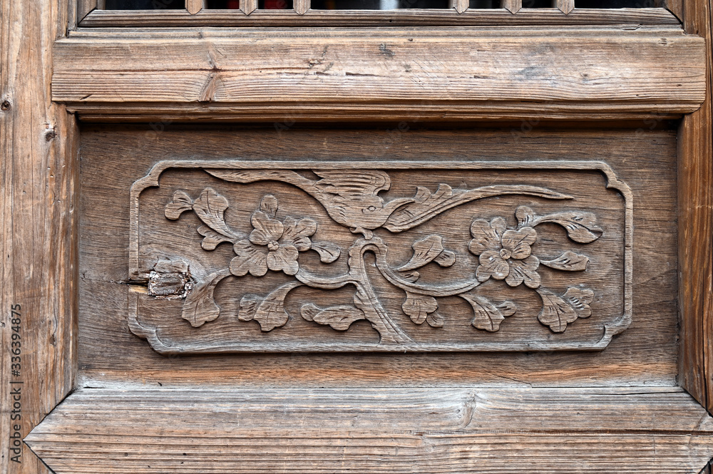 Carved patterns on wooden doors of ancient buildings in Chinese folk villages