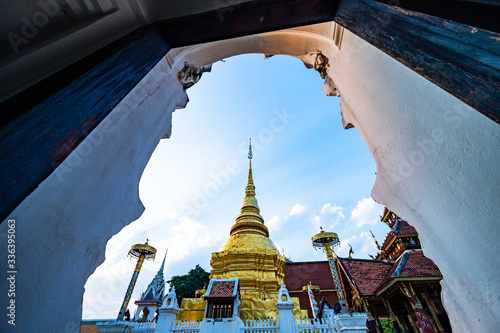 Thai style door frame with golden pagoda in Pong Sanuk temple photo