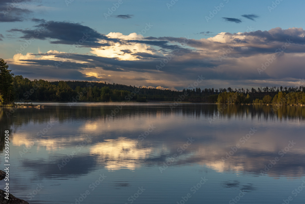 The sun setting over the lake with some interesting clouds in the sky. Sweden