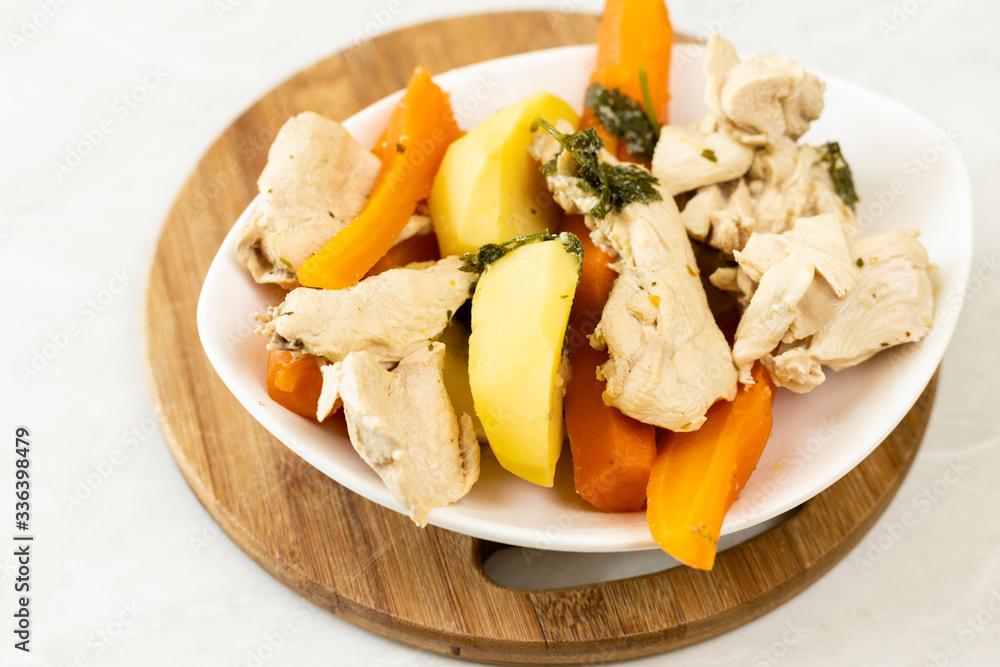 Top view of cooked chicken meat with cooked carrot and potatoes Top view of cooked chicken meat with cooked carrot and potatoes