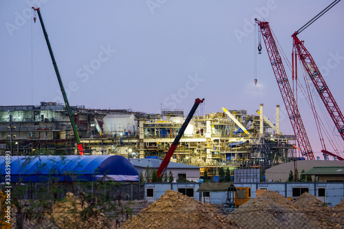 Buildings and cranes under evening construction