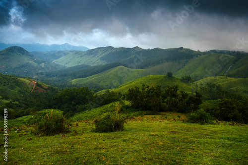 mountain landscape with green grass and clouds