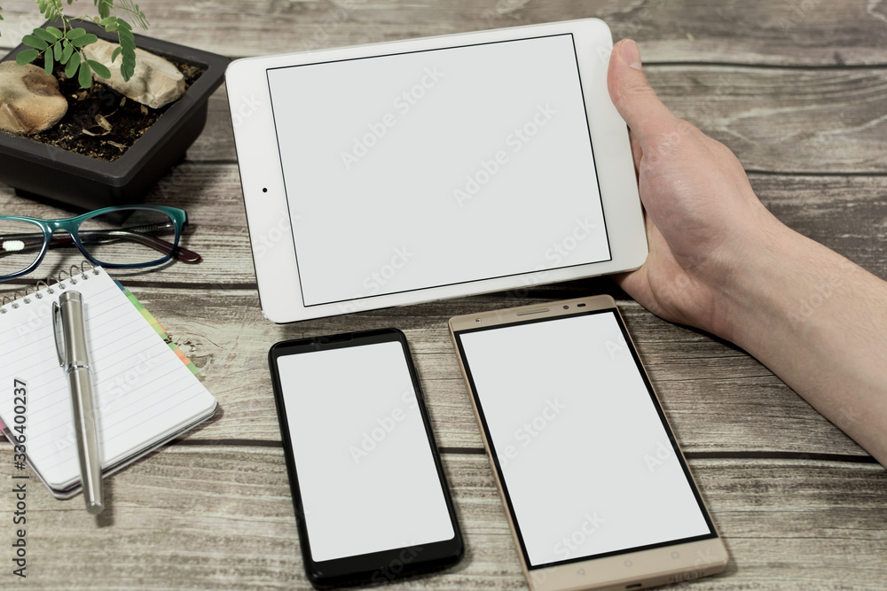 Male hands using and showing the silver tablet horizontally, phone and phablet. Male hands using and showing the silver tablet horizontally, phone and phablet.