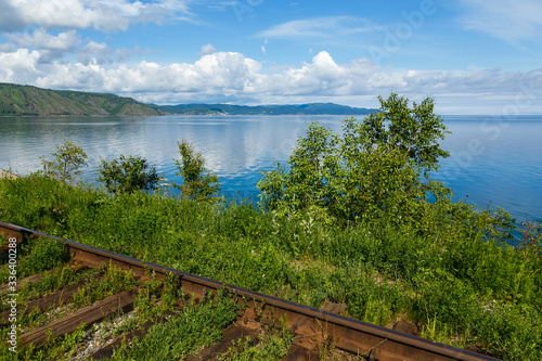 Circum-Baikal old railroad on the coast of Lake Baikal in summer with bushes