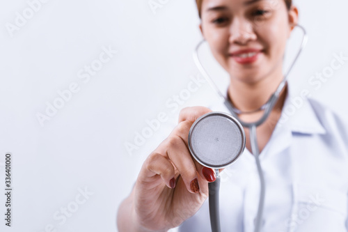 Asian female doctor holding stethoscope in hand on white background