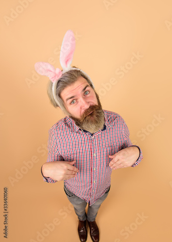 Happy Easter! Man with rabbit ears in full height. Excited man with bunny ears. Easter bunny. Easter day. Easter bunny. Egg hunt. Bunny costume. Sale. Discount. Spring holidays.