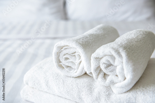 Freshly laundered fluffy towels on bed in hotel