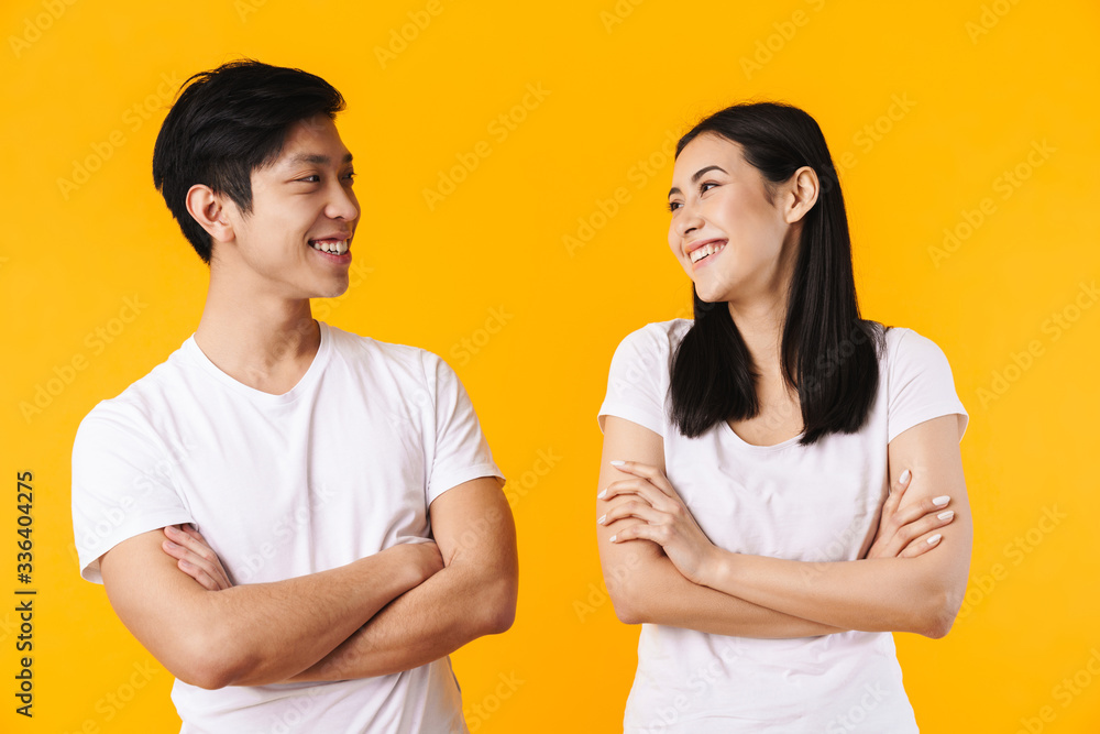 Image of multinational man and woman laughing with hands crossed Image of multinational man and woman laughing with hands crossed