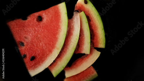 Fresh watermelon with slices isolated on black background