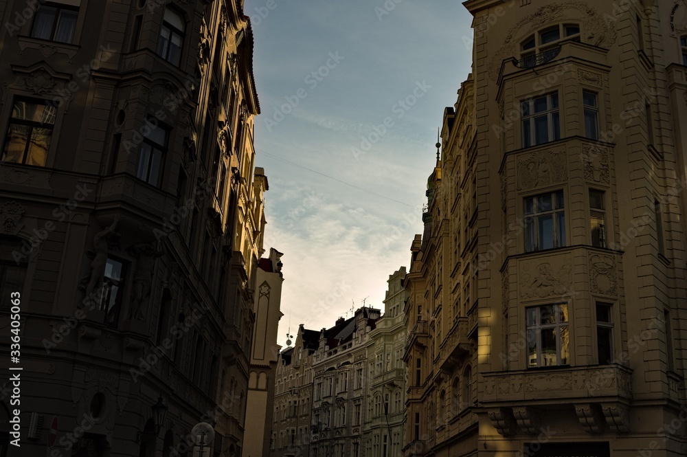 Fototapeta premium Sunset seen from a street in Prague through the buildings (Czech Republic, Europe)