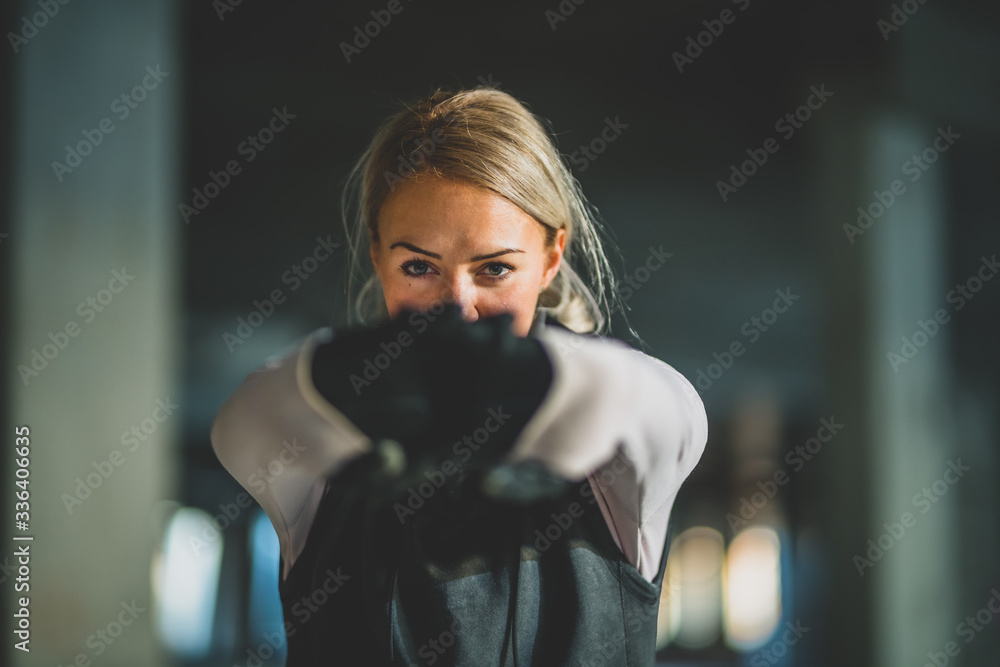 Close-up of a young Caucasian women with arms stretched out, fingers crossed