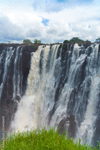 Panorama view to the dramatic waterfall and clouds at Victoria Falls on the Zambezi River  Zimbabwe  Zambia.. Vertical.