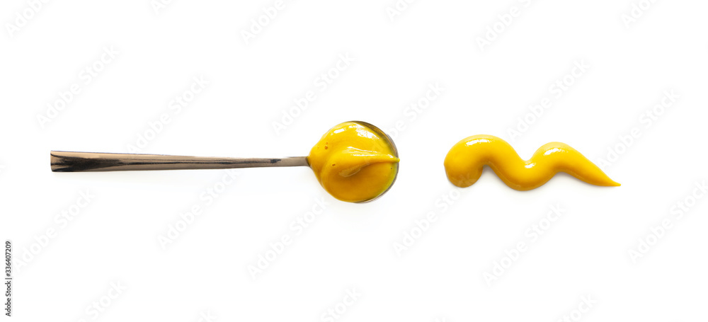 Spoon with mustard and tomato sauce splash isolated on white background, top view. Close-up seasoning and dip Spoon with mustard and tomato sauce splash isolated on white background, top view. Close-up seasoning and dip