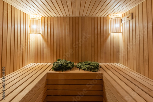 sauna bathhouse warm interior inside empty brooms barrels bucket for water © dimik_777