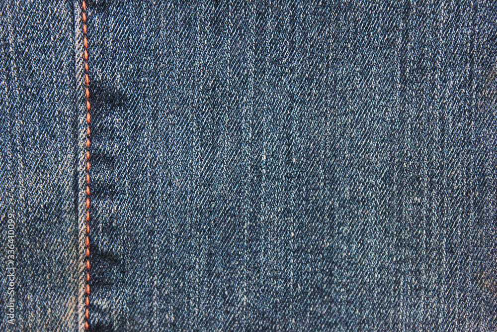 Stitch pattern on denim pants background. Empty fabric texture, seam on classic jeans close up top view Stitch pattern on denim pants background. Empty fabric texture, seam on classic jeans close up top view