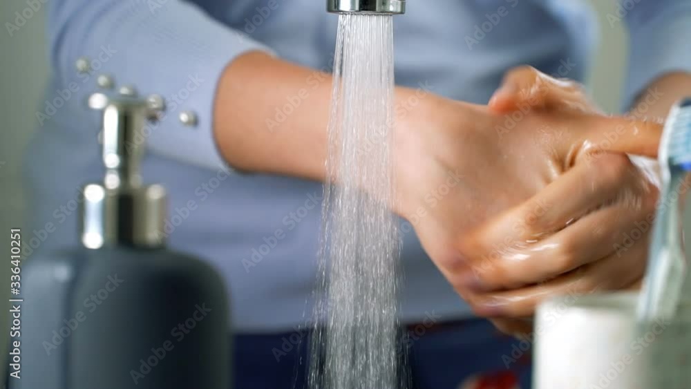 Young woman washing hands in bathroom at home, Coronavirus hand washing for clean hands hygiene. Young woman washing hands in bathroom at home, Coronavirus hand washing for clean hands hygiene.