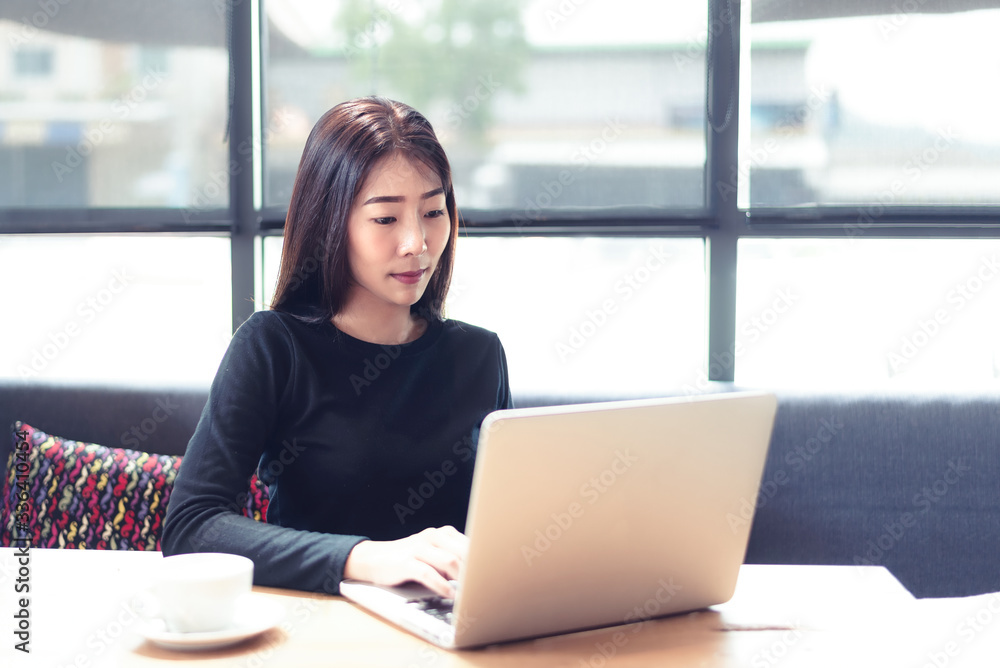 Young people work from home with laptop and drinking coffee in morning relax at home. Asia woman meeting conference connect online with office. Business and Technology Concept Young people work from home with laptop and drinking coffee in morning relax at home. Asia woman meeting conference connect online with office. Business and Technology Concept